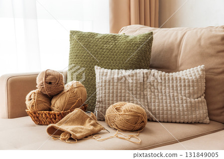 Knitting Basket with Yarn and Velvet Pumpkins in Cozy Autumn Sofa 131849005