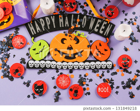Happy halloween greetings decor with pumpkins on purple orange background 131849218