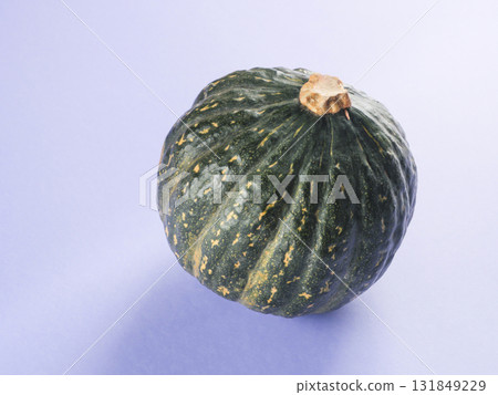 Green pumpkin on purple background Green pumpkin on purple background 131849229