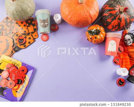 Halloween purple frame background flatlay with pumpkins and party decor Halloween purple frame background flatlay with pumpkins and party decor 131849230