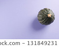 Green pumpkin on purple background 131849231