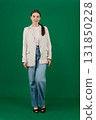 Set of photos of young European woman in light blazer and blue jeans showing various emotions gestures and expressions on green chroma key background with copy space for advertising and social media 131850228