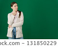 Set of photos of young European woman in light blazer and blue jeans showing various emotions gestures and expressions on green chroma key background with copy space for advertising and social media 131850229