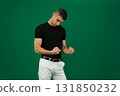 Set of videos featuring handsome European man with dark hair and expressive eyebrows wearing black t shirt and white pants showing different emotions and gestures on green chroma key background 131850232