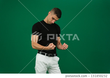 Set of videos featuring handsome European man with dark hair and expressive eyebrows wearing black t shirt and white pants showing different emotions and gestures on green chroma key background 131850232