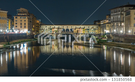 Famous Ponte Vecchio bridge timelapse over the Arno river in Florence, Italy, lit up at night 131850568