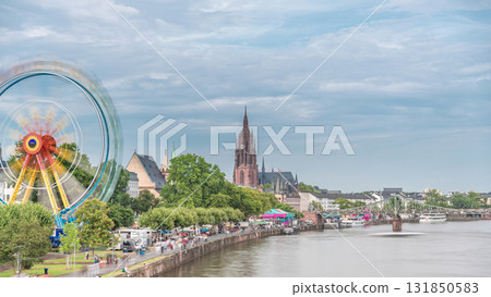 Aerial hyperlapse of pleasure boats on the Rhine Main, framed by the spire of Kaiserdom St. Bartholomaus. Germany 131850583