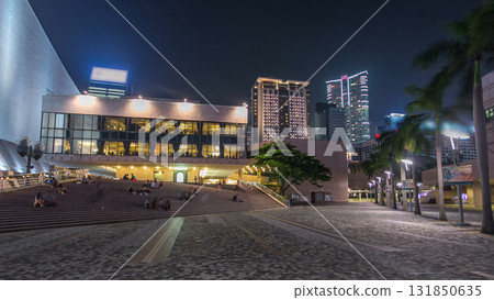 People sitting on the stairs near Hong Kong Cultural Centre with palms and towers on background timelapse hyperlapse. People sitting on the stairs near Hong Kong Cultural Centre with palms and towers on background timelapse hyperlapse. 131850635