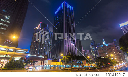 Night view hyperlapse of modern city traffic across street with skyscrapers. Time lapse. Hong Kong Night view hyperlapse of modern city traffic across street with skyscrapers. Time lapse. Hong Kong 131850647