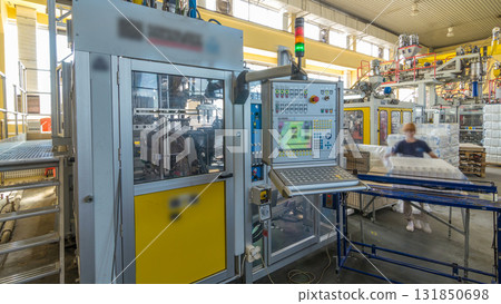 A factory for plastic canister production timelapse hyperlapse. The conveyor in the factory. A factory for plastic canister production timelapse hyperlapse. The conveyor in the factory. 131850698