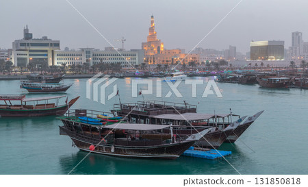 Evening at Doha Bay day to night timelapse with Traditional Wooden Dhow Fishing Boats. 131850818