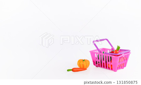 Colorful plastic shopping basket filled with vibrant vegetables and fruits, showcasing a playful grocery shopping concept with copy space Colorful plastic shopping basket filled with vibrant vegetables and fruits, showcasing a playful grocery shopping concept with copy space 131850875