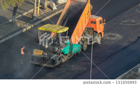 Workers operating asphalt paver machines during road construction and repairing works timelapse Workers operating asphalt paver machines during road construction and repairing works timelapse 131850893