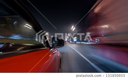 Drivelapse urban look from fast driving car at a night avenue in a city timelapse hyperlapse 131850933
