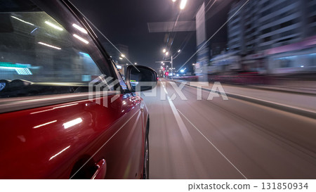 Drivelapse urban look from fast driving car at a night avenue in a city timelapse hyperlapse 131850934