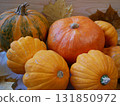 Two ripe orange pumpkins on a rustic wooden table  131850972