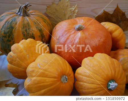 Two ripe orange pumpkins on a rustic wooden table  131850972