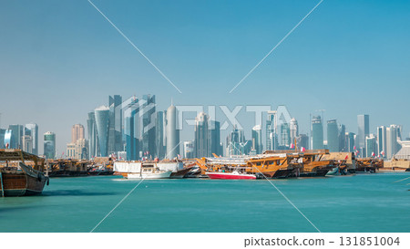 A panoramic view of the old dhow harbour timelapse in Doha, Qatar, with the West Bay skyline in the background. A panoramic view of the old dhow harbour timelapse in Doha, Qatar, with the West Bay skyline in the background. 131851004