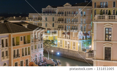 Canal aerial top view in Venice-like Qanat Quartier of the Pearl precinct of Doha night timelapse, Qatar. 131851005