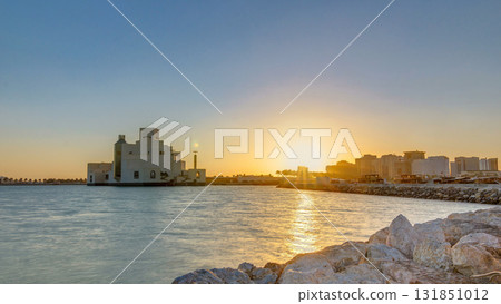 Doha Harbor with passing fishing boats during sunrise timelapse with museum of islamic art on background. Doha Harbor with passing fishing boats during sunrise timelapse with museum of islamic art on background. 131851012