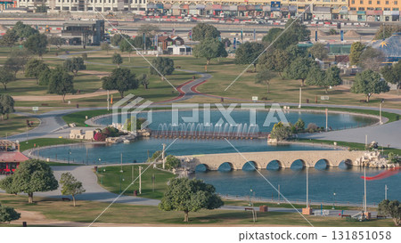 Bridge with fountain and lake in the Aspire park timelapse in Doha, Qatar Bridge with fountain and lake in the Aspire park timelapse in Doha, Qatar 131851058