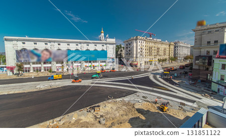 Workers operating asphalt paver machines during road construction and repairing works timelapse 131851122