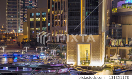 Aerial view of Dubai Marina with shopping mall, restaurants, towers and yachts night timelapse, United Arab Emirates. 131851178