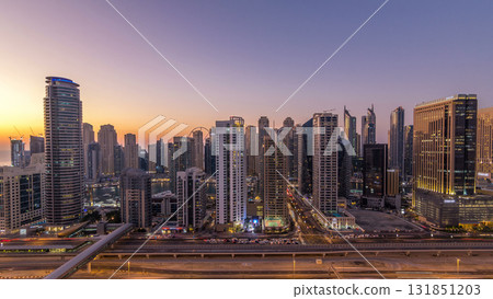 Dubai marina with traffic on sheikh zayed road panorama day to night timelapse lights turn on. Dubai marina with traffic on sheikh zayed road panorama day to night timelapse lights turn on. 131851203