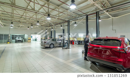 Cars moves on lifts in modern service station and men repair cars timelapse hyperlapse. Cars moves on lifts in modern service station and men repair cars timelapse hyperlapse. 131851269