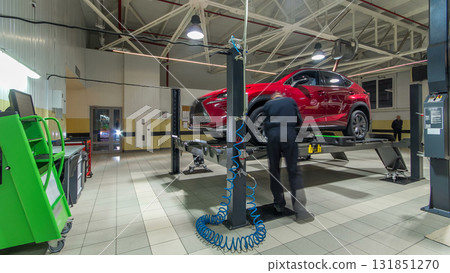 Car on stand with sensors on wheels for wheels alignment camber check in workshop of Service station timelapse. Car on stand with sensors on wheels for wheels alignment camber check in workshop of Service station timelapse. 131851270