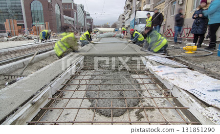 Pouring ready-mixed concrete after placing steel reinforcement to make the road by concrete mixer timelapse hyperlapse. 131851290