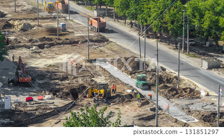 Green vibration roller compactor rolls on a stones at road construction and repairing timelapse 131851297