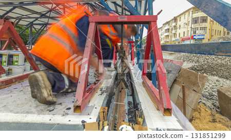 Tram rails at the stage of their installation and integration into concrete plates on the road timelapse hyperlapse. 131851299