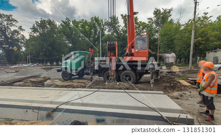 Installing concrete plates by crane at road construction site timelapse hyperlapse. Installing concrete plates by crane at road construction site timelapse hyperlapse. 131851301