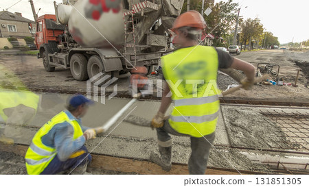 Concrete works for road construction with many workers and mixer timelapse hyperlapse 131851305
