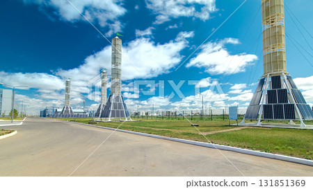 Solar Panel towers on solar plant with High Voltage Tower in Background timelapse hyperlapse Solar Panel towers on solar plant with High Voltage Tower in Background timelapse hyperlapse 131851369