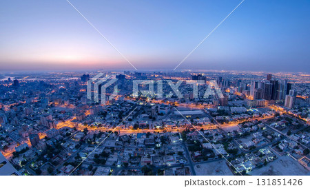 Cityscape of Ajman from rooftop night to day timelapse. Ajman is the capital of the emirate of Ajman in the United Arab Emirates. Cityscape of Ajman from rooftop night to day timelapse. Ajman is the capital of the emirate of Ajman in the United Arab Emirates. 131851426