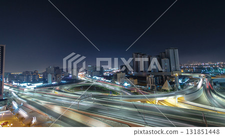 Traffic on a big road junction in Ajman aerial view from rooftop at night timelapse. Traffic on a big road junction in Ajman aerial view from rooftop at night timelapse. 131851448