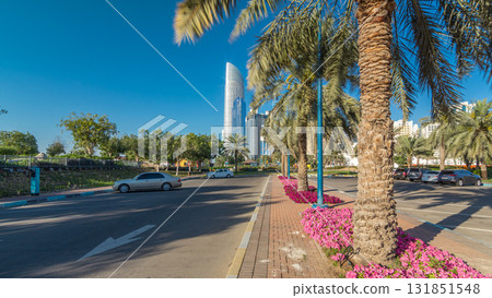Corniche boulevard beach park along the coastline in Abu Dhabi timelapse hyperlapse with skyscrapers on background. Corniche boulevard beach park along the coastline in Abu Dhabi timelapse hyperlapse with skyscrapers on background. 131851548