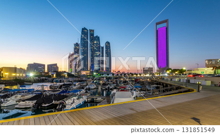 Al Bateen marina Abu Dhabi day to night timelapse with modern skyscrapers on background Al Bateen marina Abu Dhabi day to night timelapse with modern skyscrapers on background 131851549