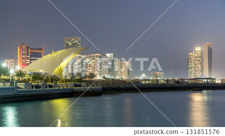 Promenade in Abu Dhabi illuminated at dusk, day to night timelapse. 131851576