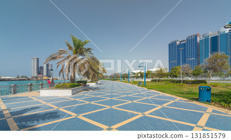 Corniche boulevard beach park along the coastline in Abu Dhabi timelapse hyperlapse with skyscrapers on background. Corniche boulevard beach park along the coastline in Abu Dhabi timelapse hyperlapse with skyscrapers on background. 131851579