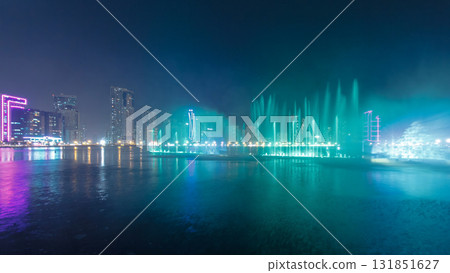 Evening Musical fountain show. Singing fountains in Sharjah timelapse, UAE Evening Musical fountain show. Singing fountains in Sharjah timelapse, UAE 131851627