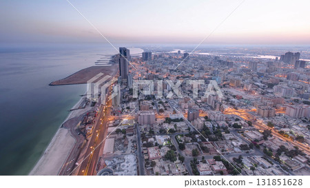Cityscape of Ajman from rooftop night to day timelapse. Ajman is the capital of the emirate of Ajman in the United Arab Emirates. Cityscape of Ajman from rooftop night to day timelapse. Ajman is the capital of the emirate of Ajman in the United Arab Emirates. 131851628