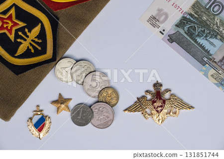 Russian Soviet military cap with service patches with ruby stars and hammer and sickle emblems. Medal with double headed eagle and red coat of arms. High quality photo 131851744