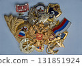 Macro stack including two gold Russian Soviet military gold double headed eagle and coat of arms medal with red field. Russian Federation flag pin. Ruby star, hero of nation. Several other medals 131851924