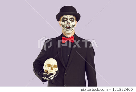 Portrait of man with skeleton makeup who is looking at you with surprised and shocked expression. Portrait of man with skeleton makeup who is looking at you with surprised and shocked expression. 131852400