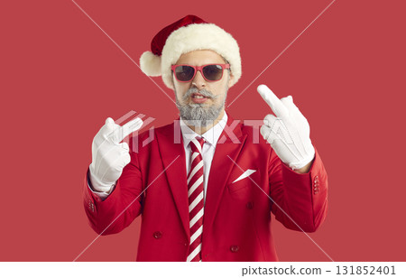 Cool cheeky man in Santa hat showing middle finger demonstrating that go fuck you. 131852401