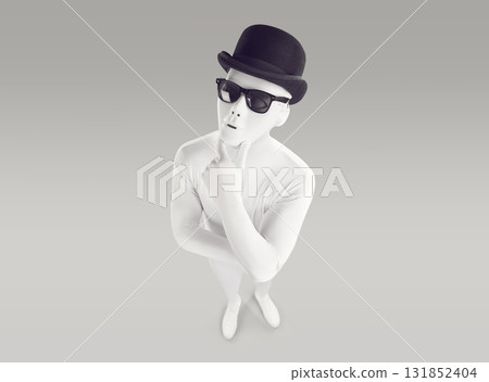 Mysterious man in white bodysuit, black hat and sunglasses trying to answer question and thinking Mysterious man in white bodysuit, black hat and sunglasses trying to answer question and thinking 131852404