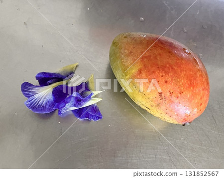 Ripe mango and butterfly pea flower Ripe mango and butterfly pea flower 131852567